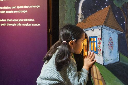 Children exploring interactive displays at the Fairy Tales exhibition at the British Library