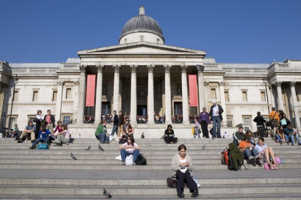 Visitors sitting on the steps in front of the National Gallery in London @ National Gallery