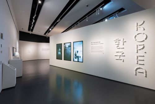 Entrance gallery of the Korea exhibition with bilingual title wall and digital object displays