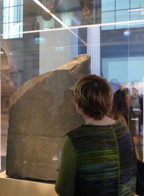 Expert guide during a private tour explaining the Rosetta Stone inside the British Museum