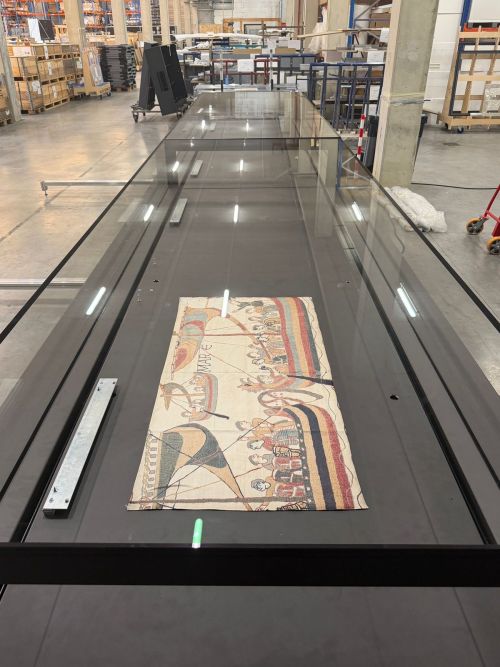 Glass display case built for the Bayeux Tapestry, tested with a facsimile