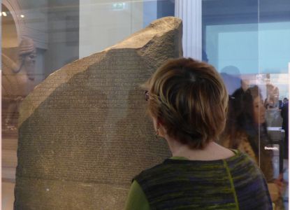 Expert guide during a private tour explaining the Rosetta Stone inside the British Museum