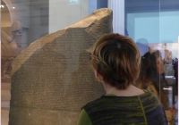 Expert guide during a private tour explaining the Rosetta Stone inside the British Museum