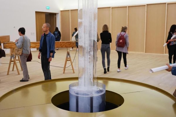 Gallery space at Tate Modern with visitors walking around a modern art installation