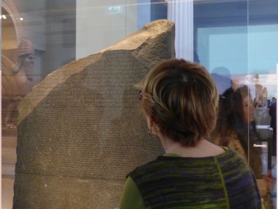 Expert guide during a private tour explaining the Rosetta Stone inside the British Museum